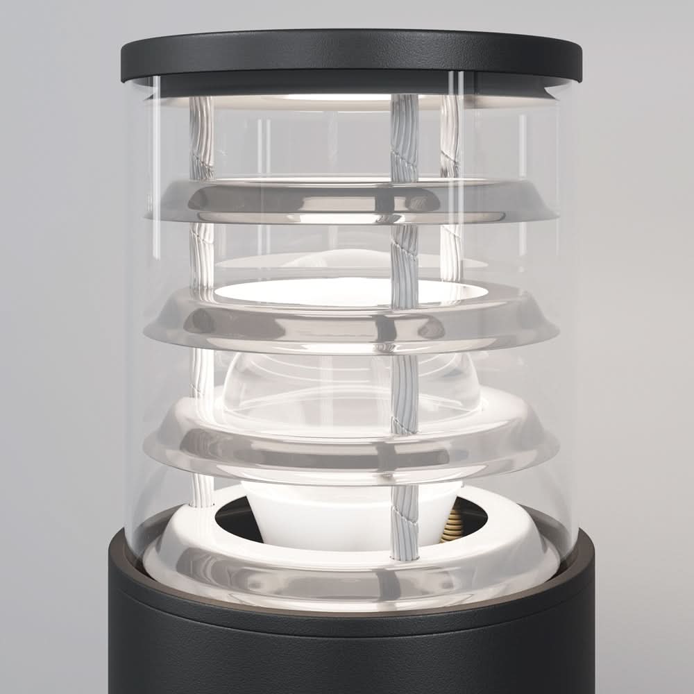 Gros plan sur la partie vitrée et les anneaux internes du luminaire extérieur.
