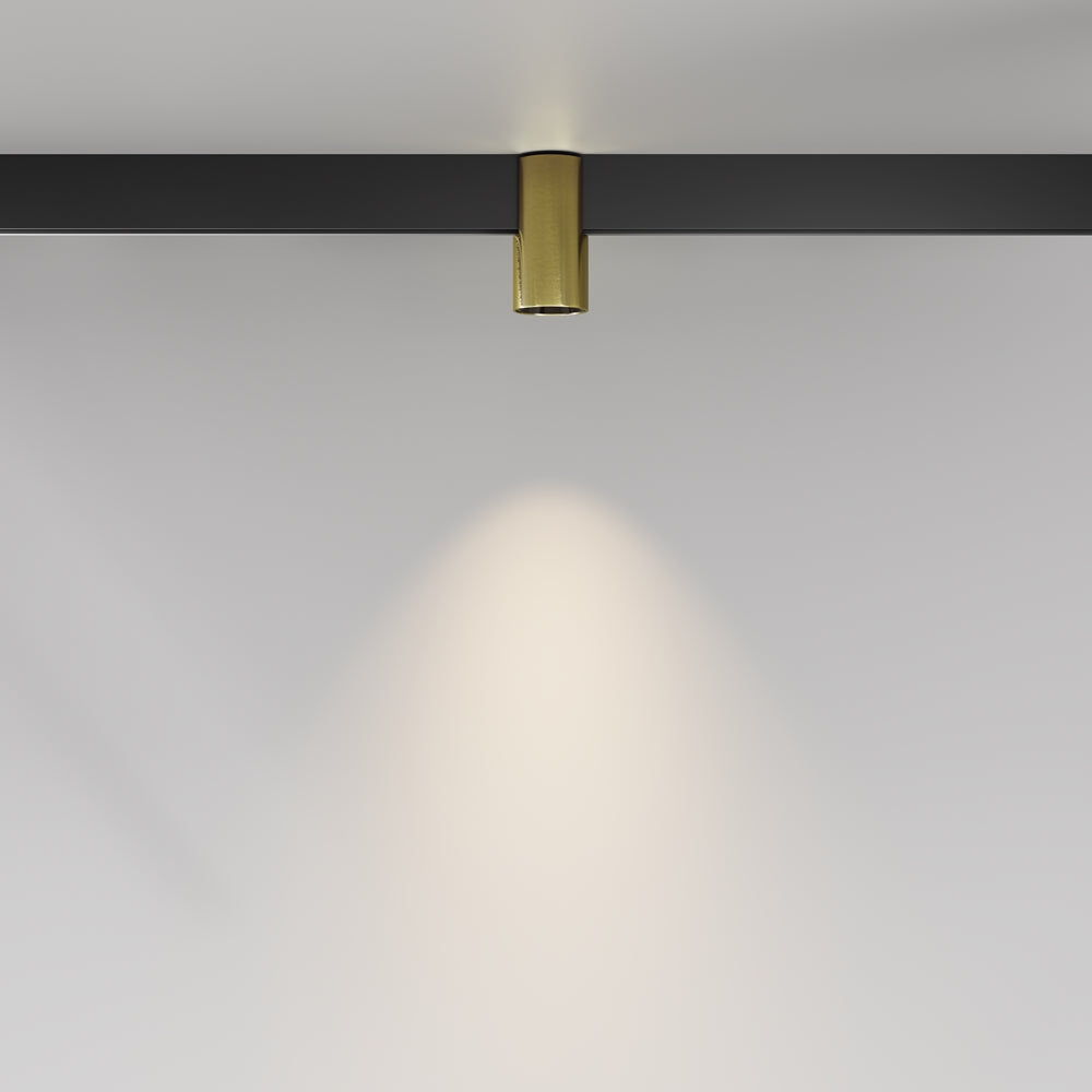 Mise en ambiance : halo lumineux blanc projeté sur un mur gris pâle.