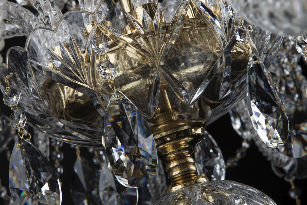 Vue rapprochée de la coupe ciselée et des chaînettes de cristal suspendues.