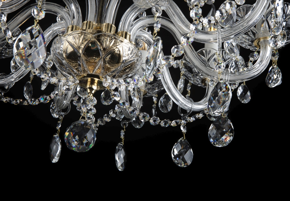 Détail des bras courbes en verre et du noeud central doré