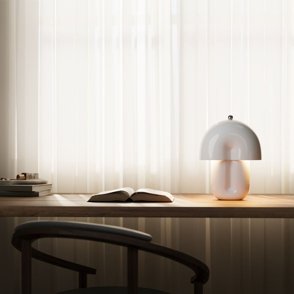 Mise en ambiance sur un bureau en bois, livre ouvert et rideaux translucides