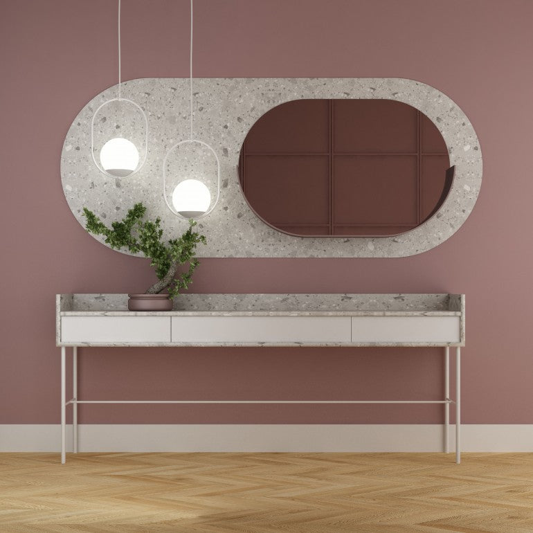 Mise en ambiance avec deux suspensions devant un miroir, mur rose et buffet.