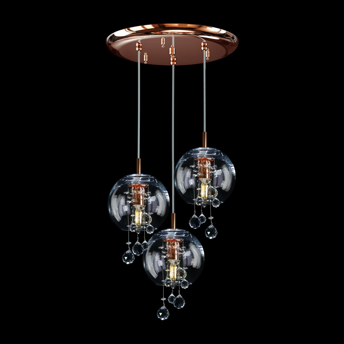 Suspension design en métal finition cuivrée, trois boules transparentes et cristaux scintillants.