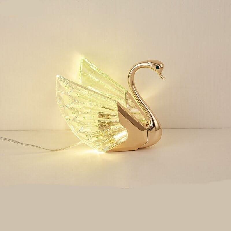 Vue de profil du cygne illuminé, câble d'alimentation visible sur fond beige