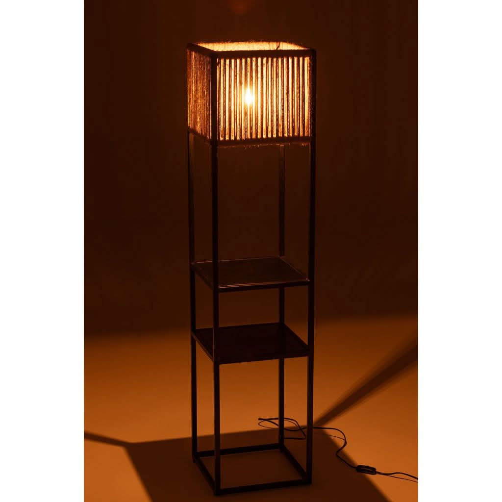 Lampe allumée dans ambiance sombre, lumière chaude traversant la corde de jute.