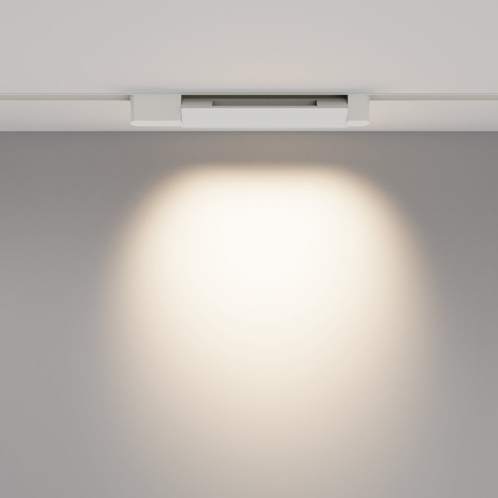 Mise en ambiance : halo de lumière chaude projeté sur une surface claire