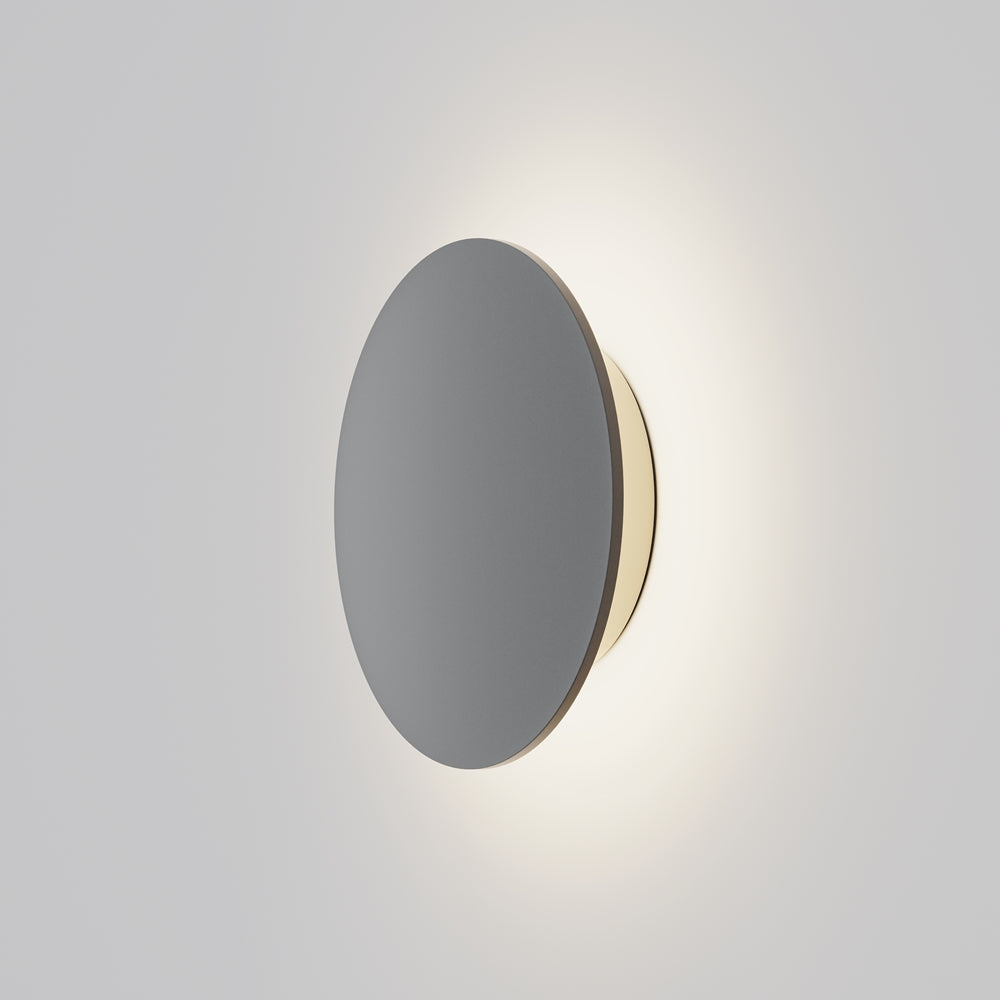 Applique murale ronde vue de face, halo lumineux diffusé sur la paroi claire