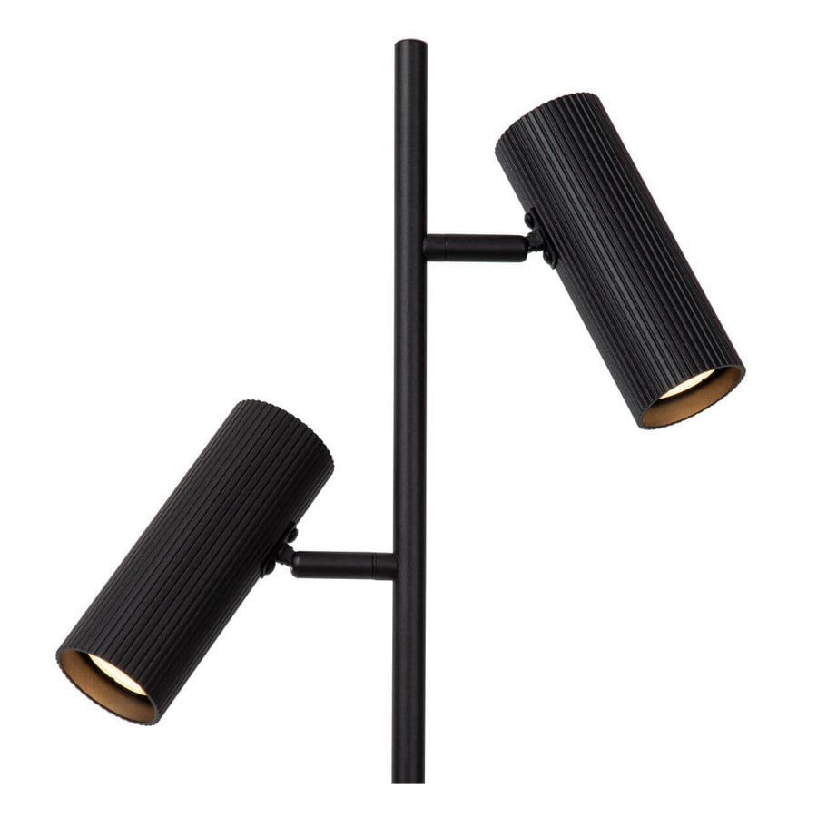 Gros plan sur les deux projecteurs cylindriques noirs, intérieur doré et nervures.