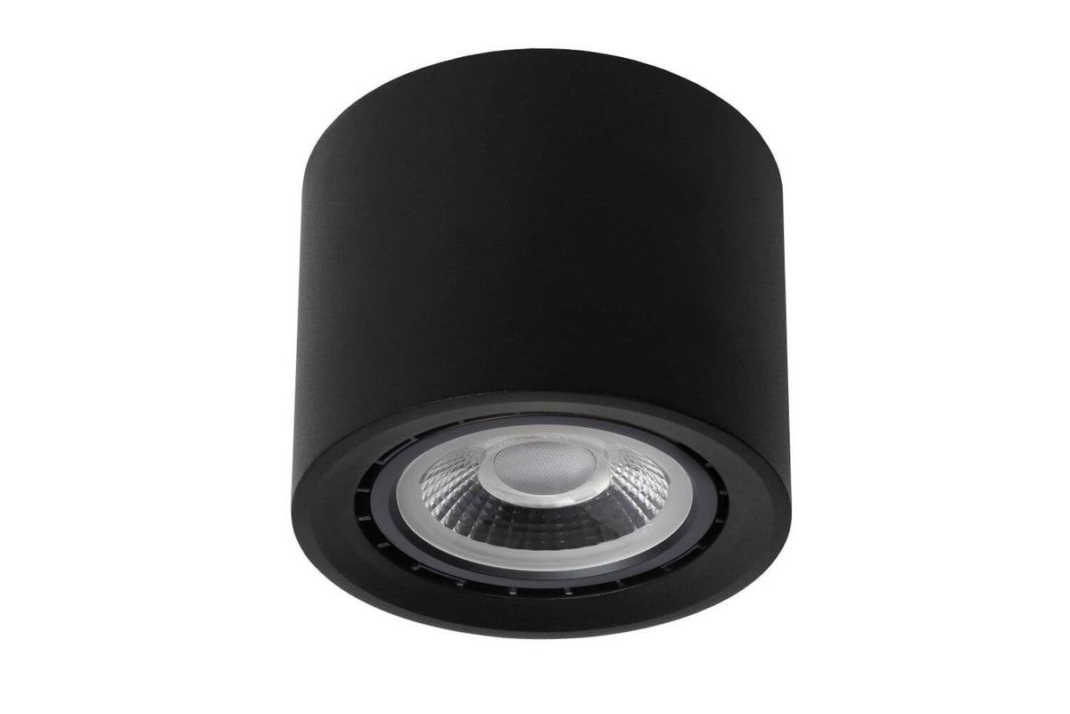 Plafonnier cylindrique noir éteint, réflecteur transparent et bord cannelé visibles.