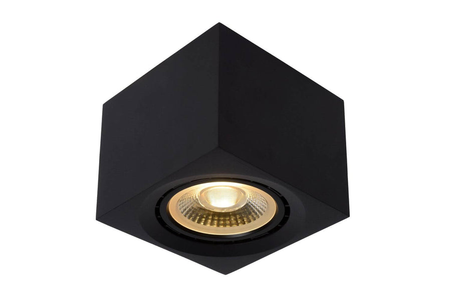 Vue de face du luminaire cubique noir allumé, dévoilant l'ampoule dorée en son centre