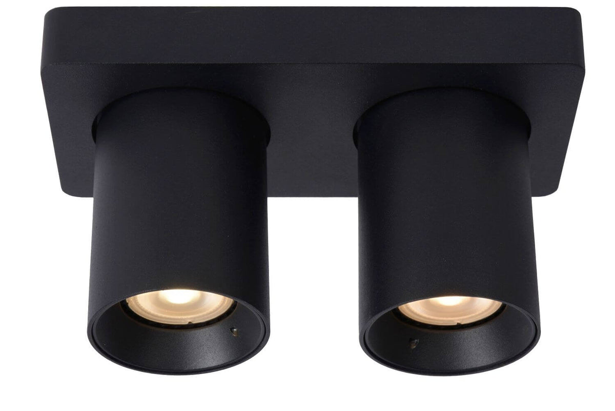 Vue de face du plafonnier noir avec deux cylindres orientables vers le bas.