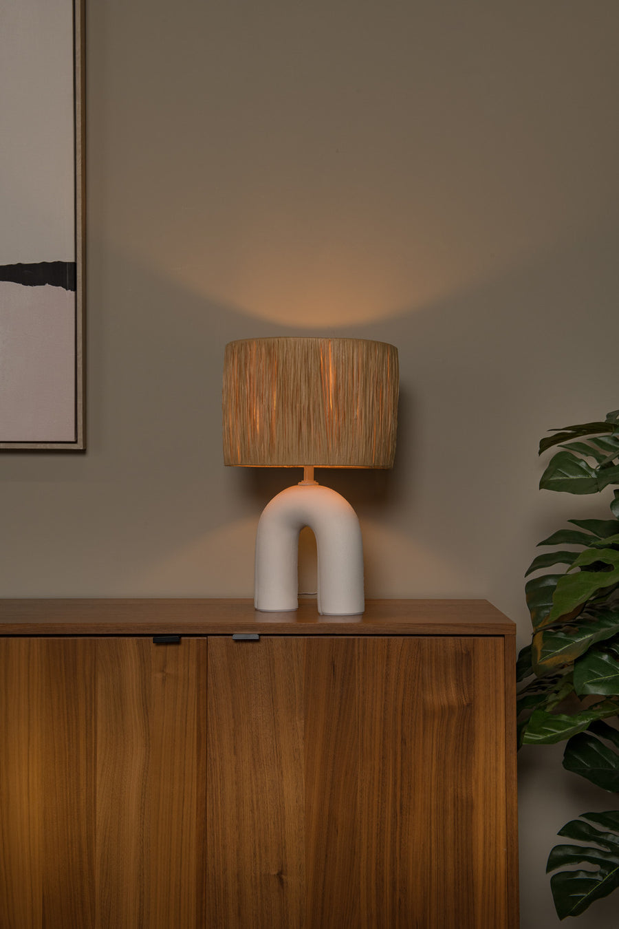 Vue rapprochée de la lampe allumée près d'une plante verte, sur meuble