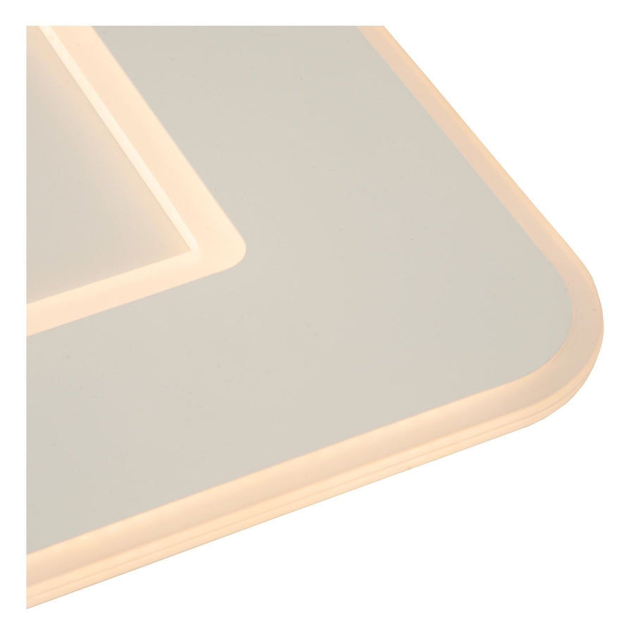 Détail d'un coin arrondi du luminaire, bordure LED allumée sous diffuseur blanc