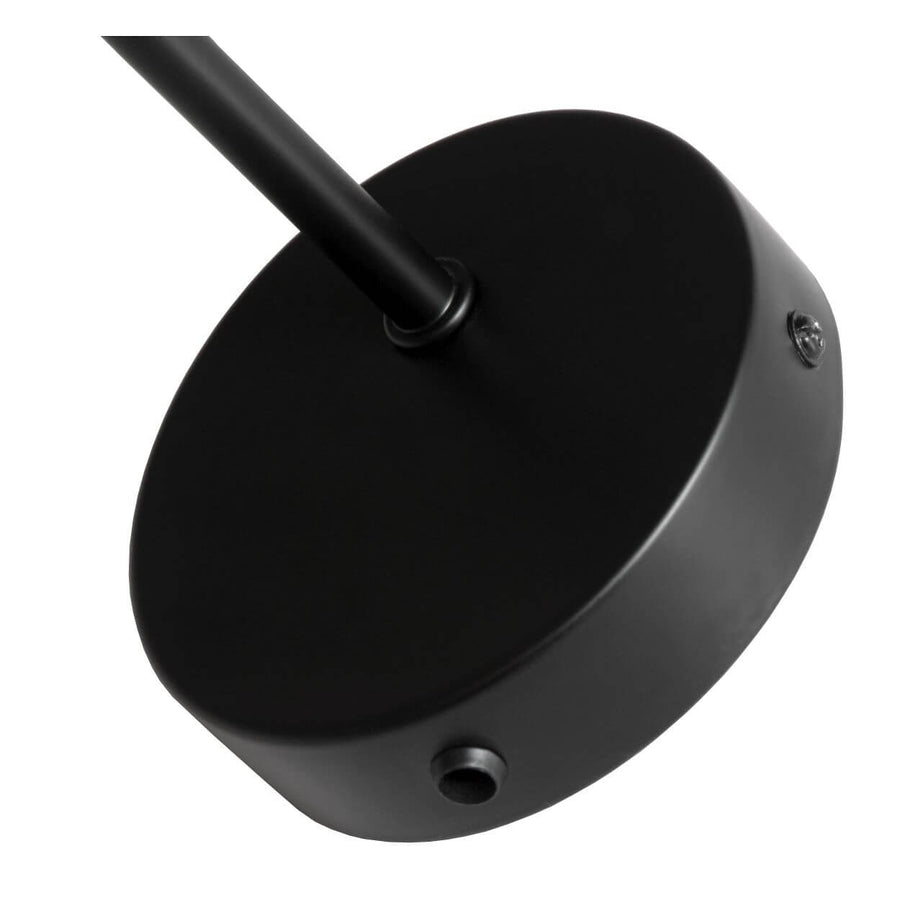 Détail rapproché de la platine ronde noire fixée au mur par vis