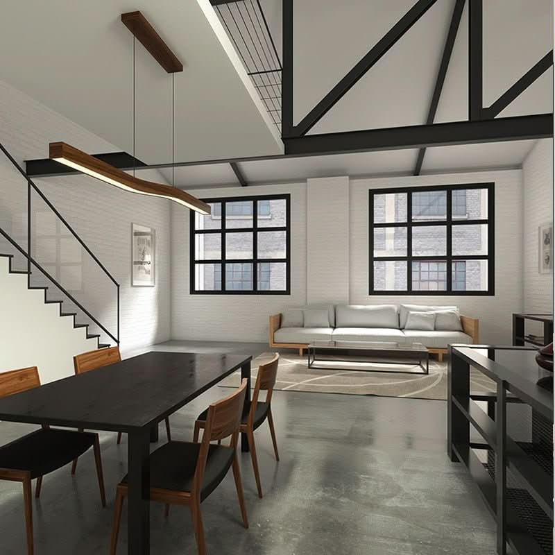 Suspension bois vue de loin dans un séjour loft aux poutres noires apparentes