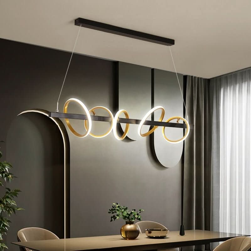Détail du luminaire installé dans un intérieur sombre, mettant en valeur les anneaux