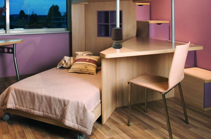 Mise en ambiance dans une chambre avec lampe posée sur un bureau en bois clair.