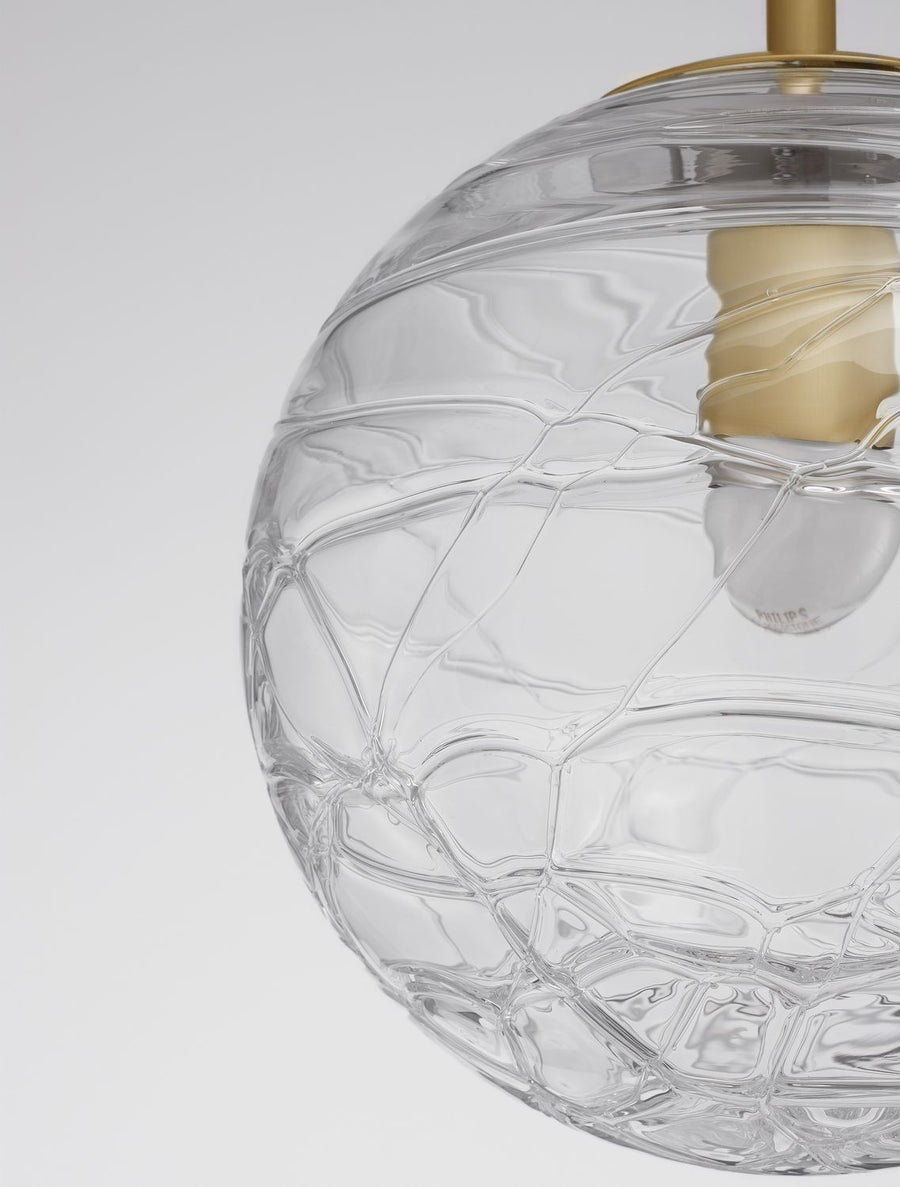 Détail rapproché du verre texturé en nid d'abeille et de la douille dorée