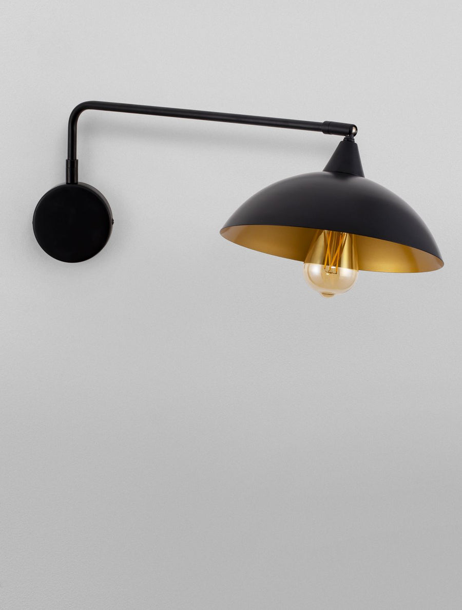 Gros plan sur l'abat-jour noir et son intérieur doré, ampoule éteinte