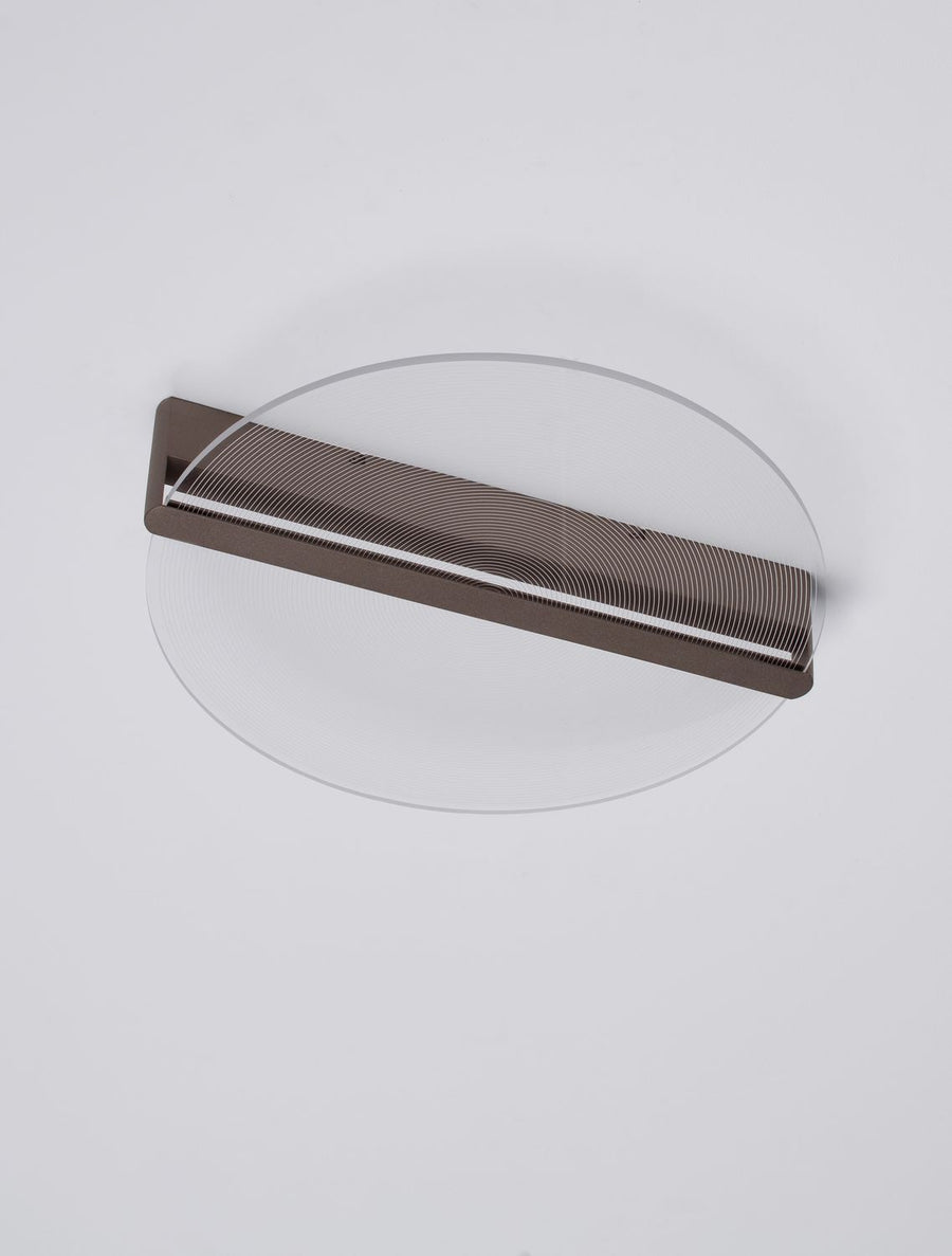 Disque lumineux vu de dessus sur fond blanc, monture marron fine