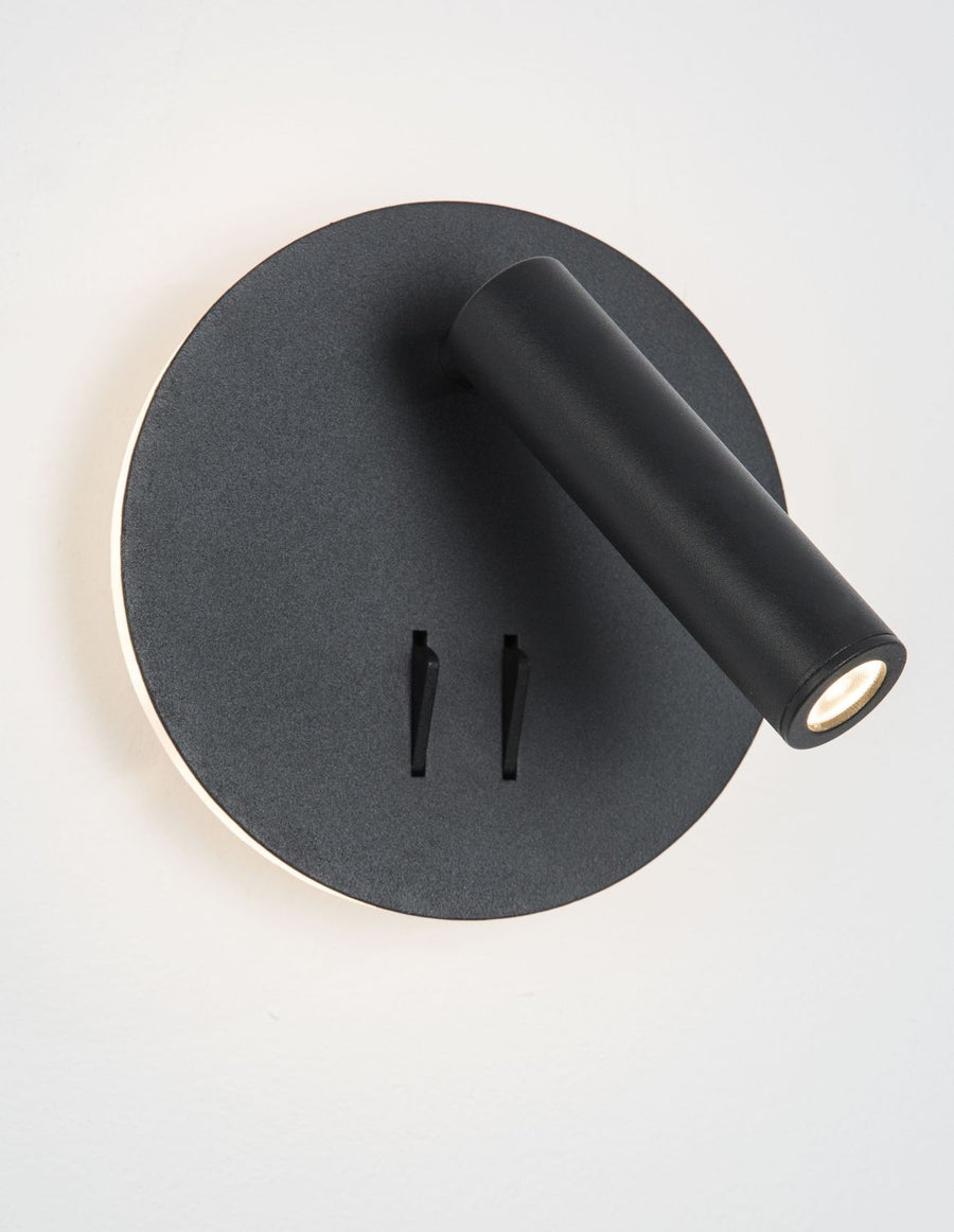 Vue de trois quarts montrant le socle circulaire noir et le bras lumineux orientable