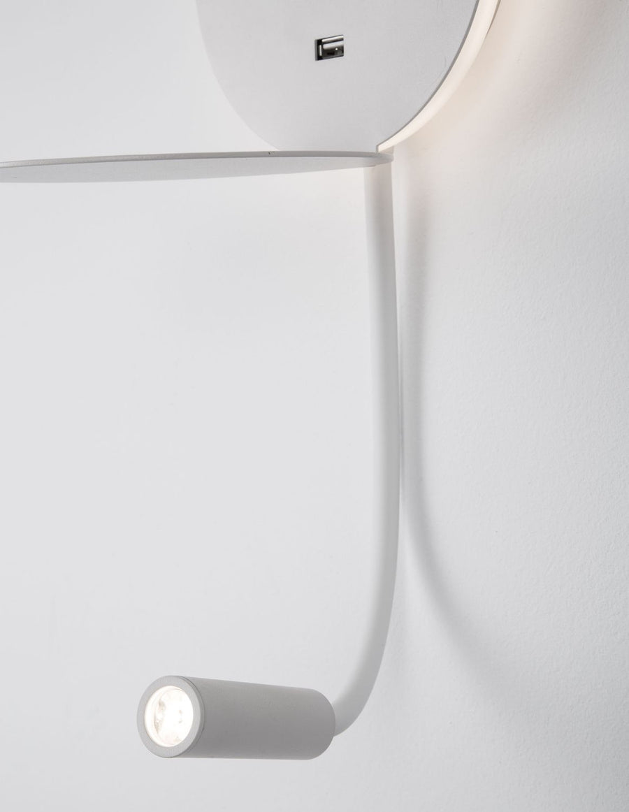 Détail du bras flexible et de la tête lumineuse, port USB sur applique blanche.