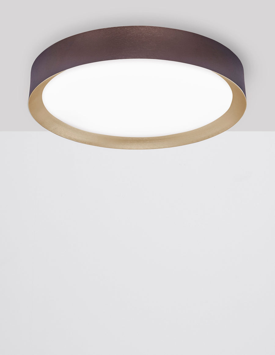 Luminaire vu de dessous montrant le diffuseur blanc et l'anneau doré