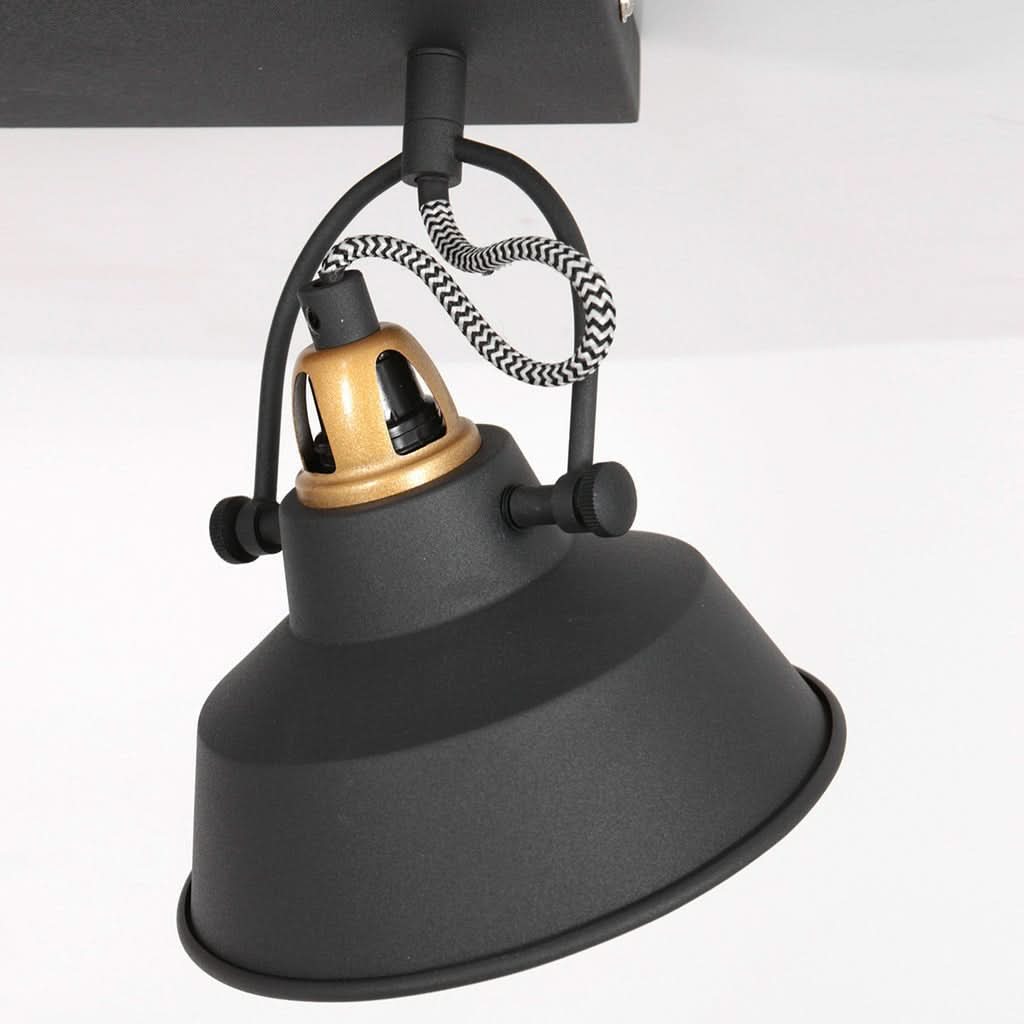 Détail d'une suspension à corde tressée noire et blanche et cabochon doré