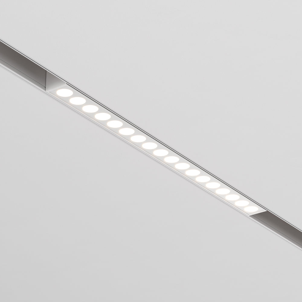 Profil en aluminium clair encastré, série de diodes rondes blanches formant une ligne continue.