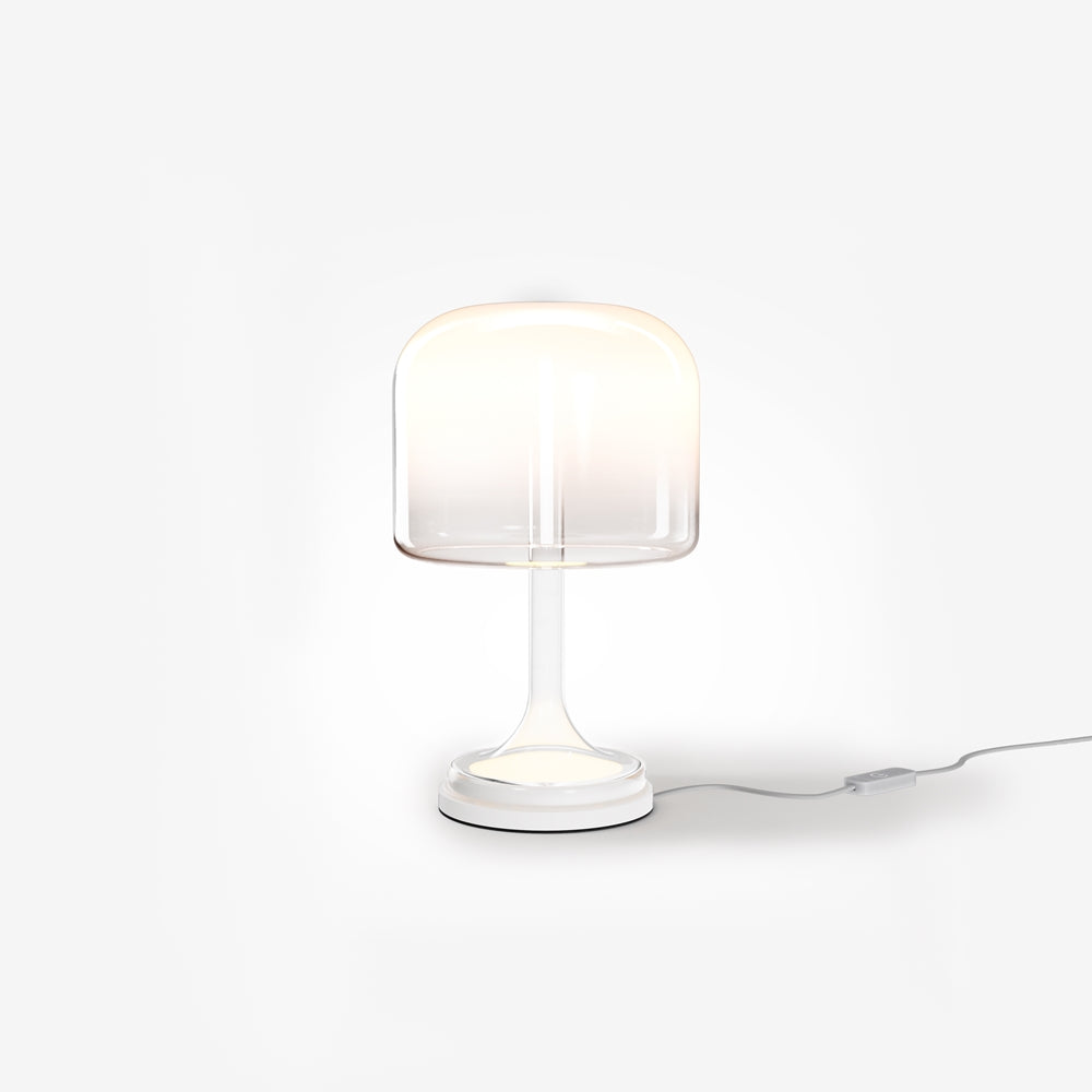 Lampe de chevet blanche à abat-jour cylindrique en verre, socle et câble visibles.