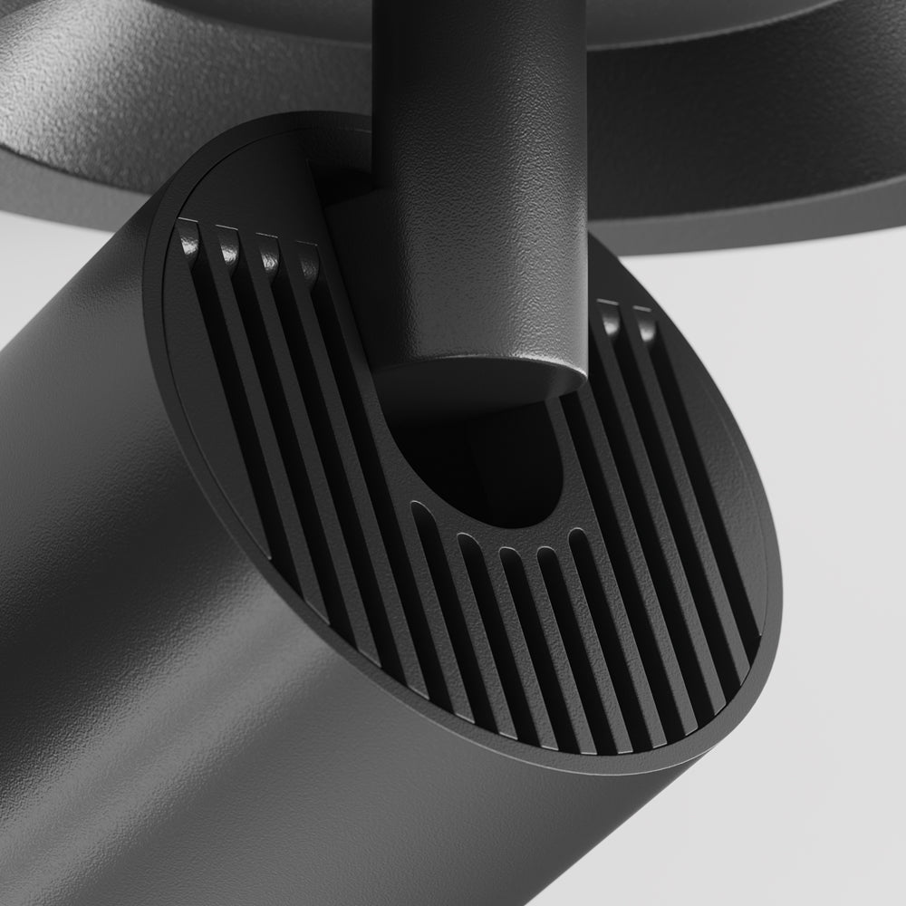 Détail rapproché des ailettes noires du dissipateur et de l'articulation du projecteur
