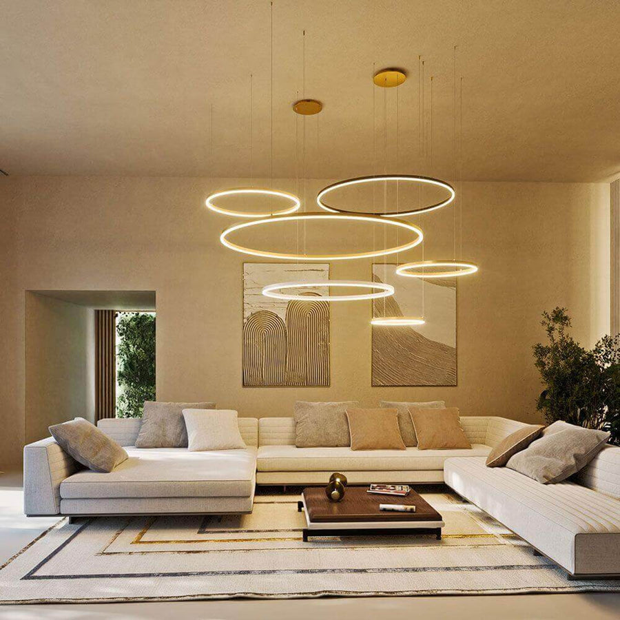 Suspension cinq anneaux LED allumés au plafond d'un salon contemporain beige