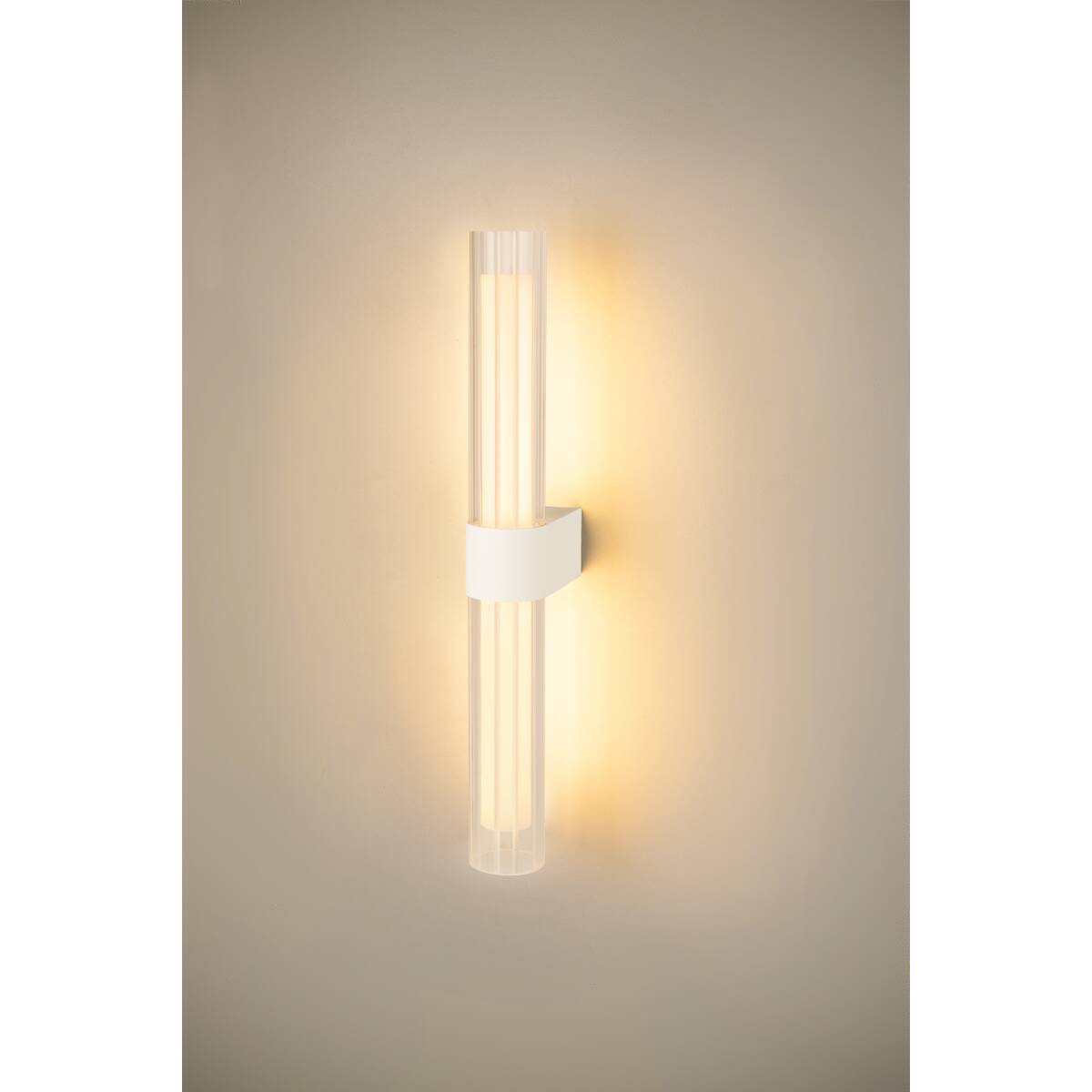 Applique allumée sur un mur beige, diffusant une lumière chaude en halo.