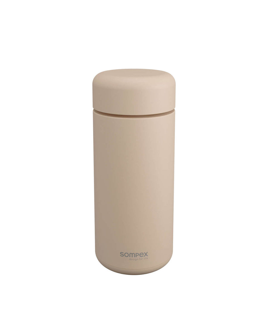 Lampe nomade beige éteinte, capot fermé, produit présenté de face sur fond blanc