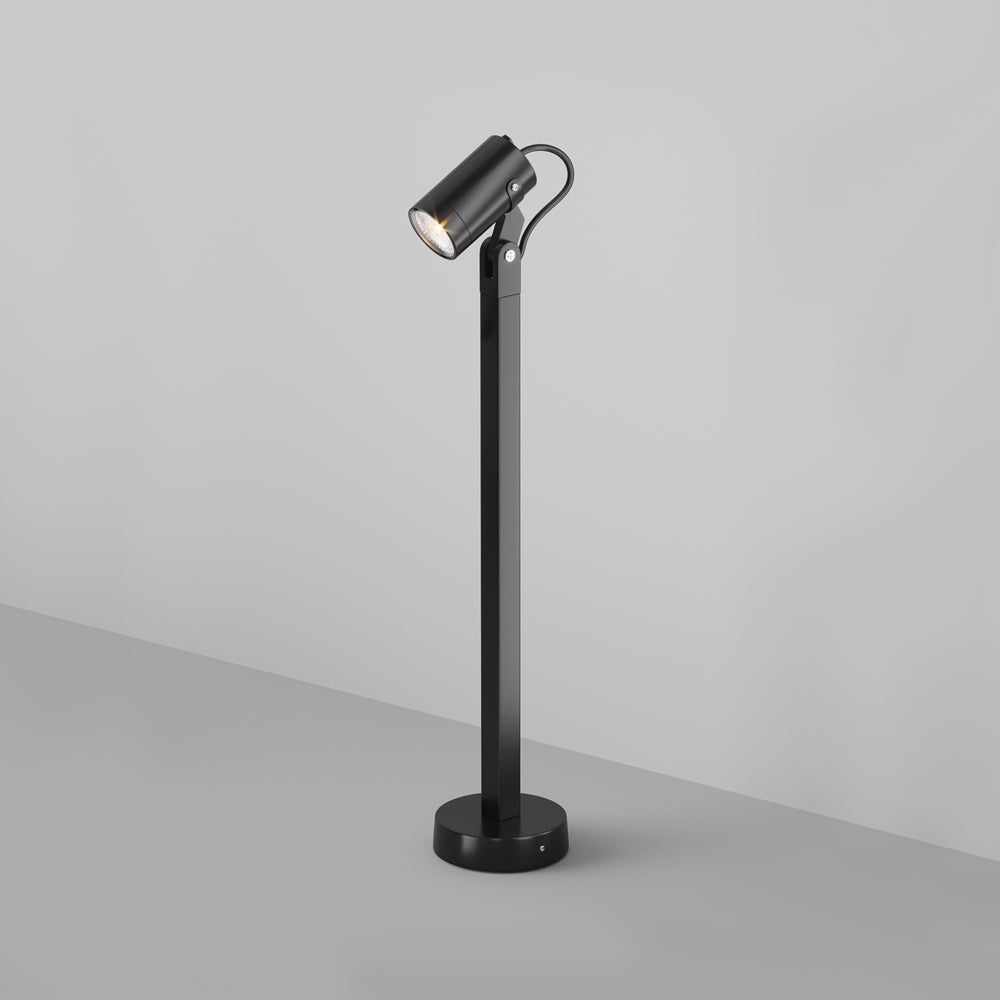 Luminaire monté sur une tige avec embase ronde, posé au sol