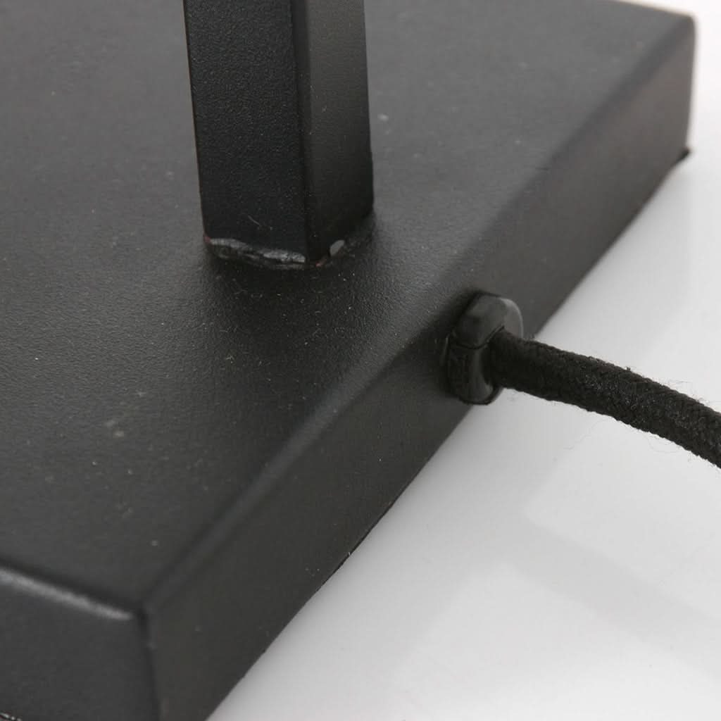 Détail de la base rectangulaire noire avec sortie de cordon et interrupteur rotatif.
