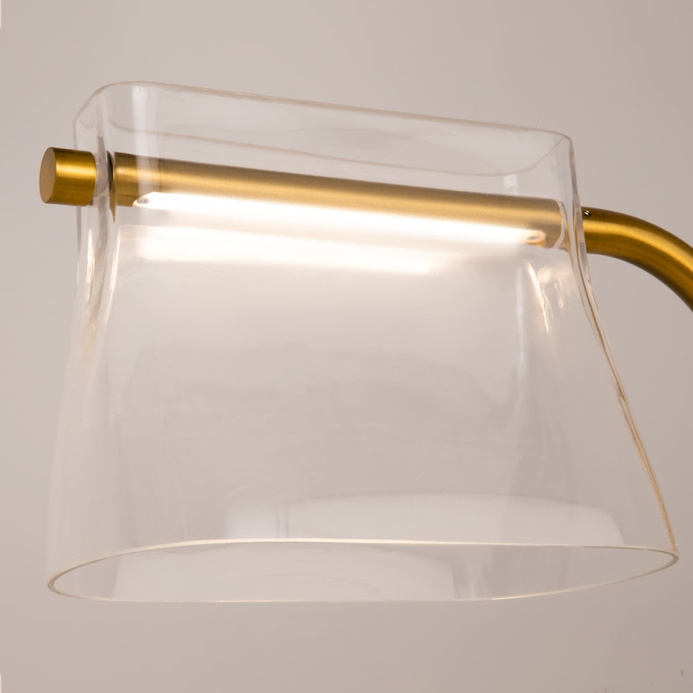 Gros plan sur l'abat-jour transparent et la barre lumineuse dorée