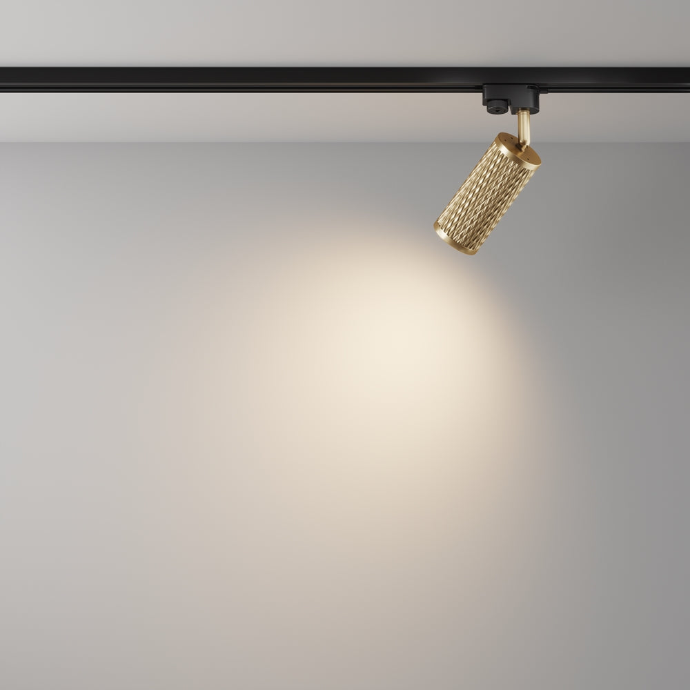 Mise en ambiance avec halo lumineux chaud projeté sur un mur clair.