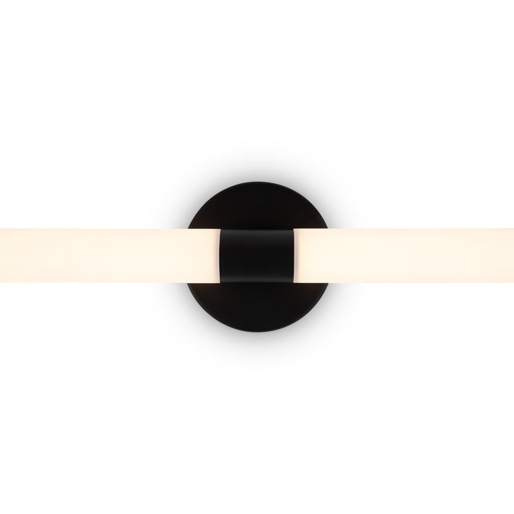 Gros plan sur la platine ronde noire et le tube horizontal en verre opalin