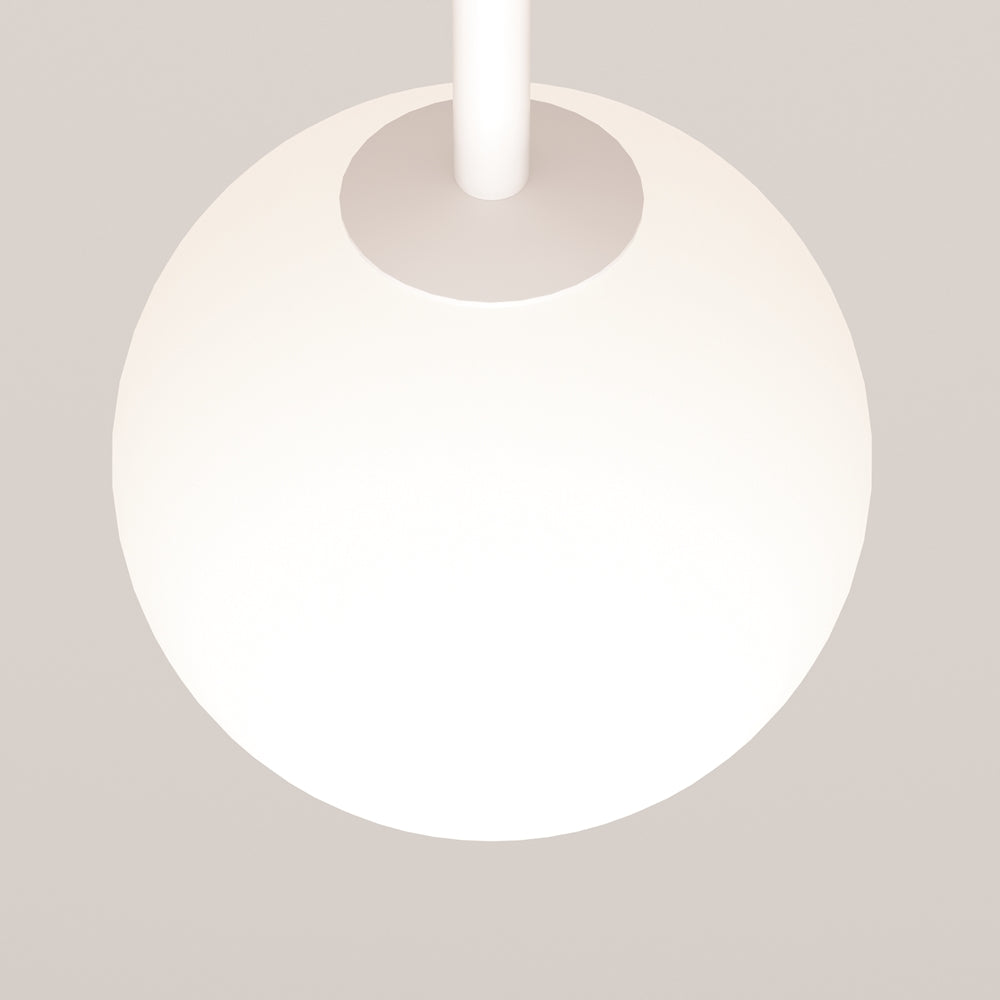 Détail rapproché de la sphère blanche allumée et de son support cylindrique blanc.