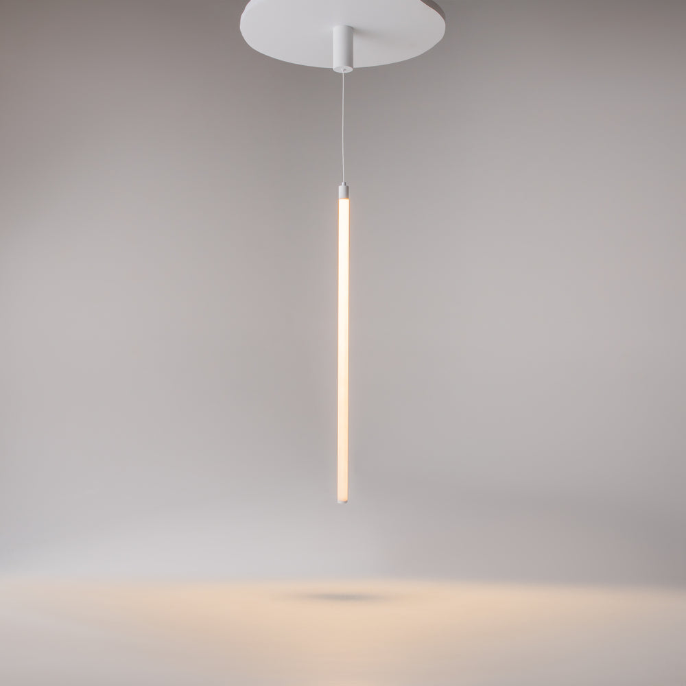 Rosace ronde plate au plafond et long tube vertical lumineux sur fond gris