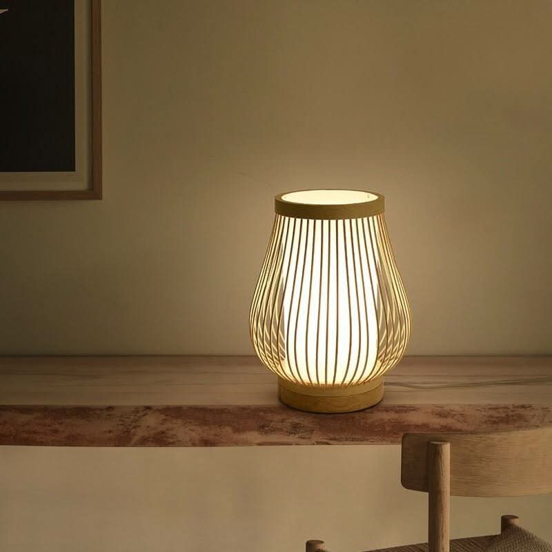 Variante arrondie de la lampe, éclairée sur une étagère en bois et marbre